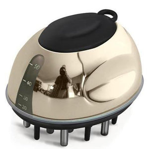 Gold and black scalp massager on a white background